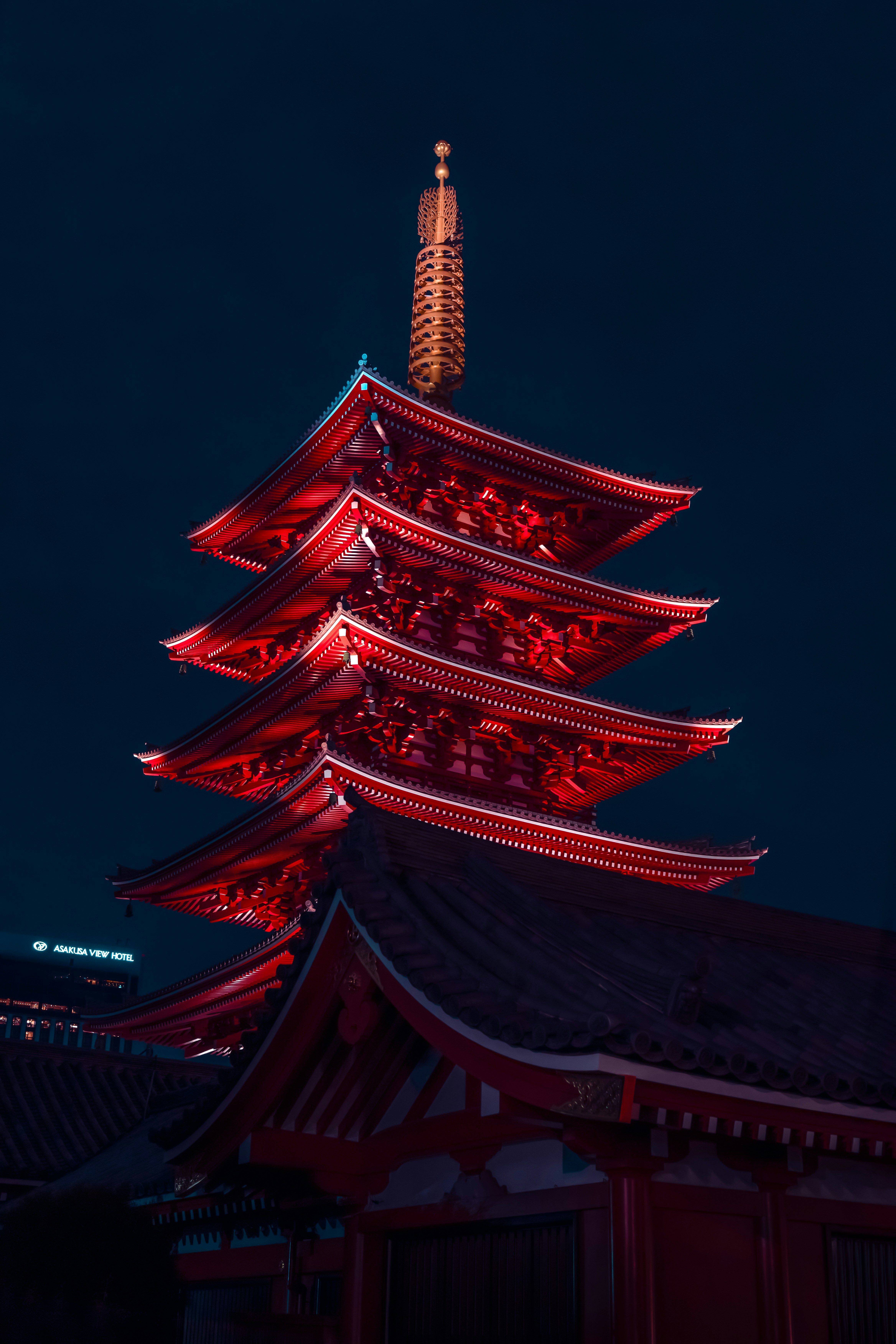 a tall building with a tower lit up at night